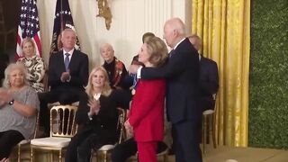 Biden gives Hillary Clinton award, appears to kiss her at end