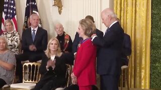 Biden gives Hillary Clinton award, appears to kiss her at end