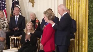 Biden gives Hillary Clinton award, appears to kiss her at end