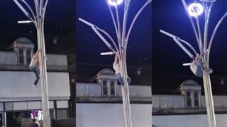 Man climbs weird light post to save a seagull