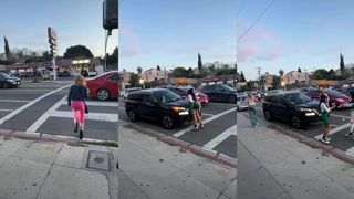 Group of women throw drinks at car in traffic