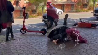 Woman tips scooter, then falls flat on her face