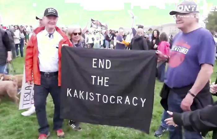 Protester doesn't know what he's doing, needs to read paper to remember