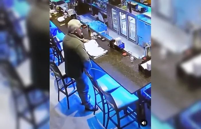 Dude takes a leak at the bar, caught on camera