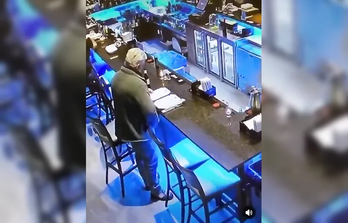 Dude takes a leak at the bar, caught on camera
