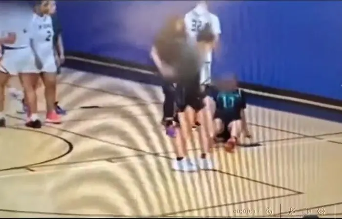 Giant male injures 3 girls during basketball game, coach throws in the towel