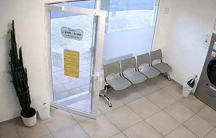 Guy walks out of laundromat right before it EXPLODES