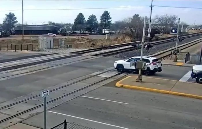 Driver JUMPS out of car, leaving it to get SMASHED by train