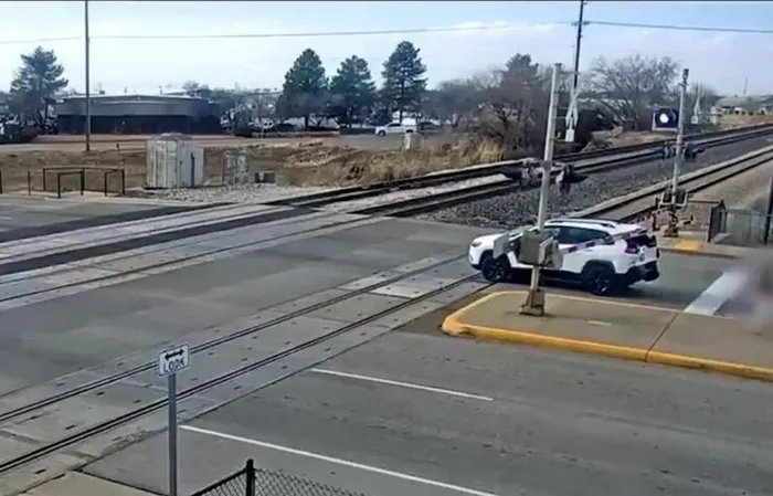 Driver JUMPS out of car, leaving it to get SMASHED by train