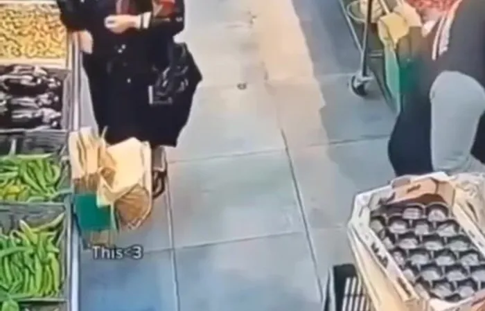 Elderly woman and supermarket worker have a standoff