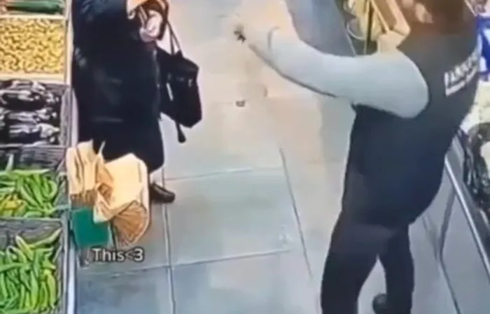 Elderly woman and supermarket worker have a standoff