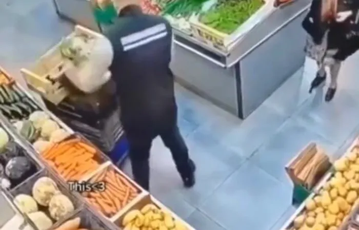 Elderly woman and supermarket worker have a standoff