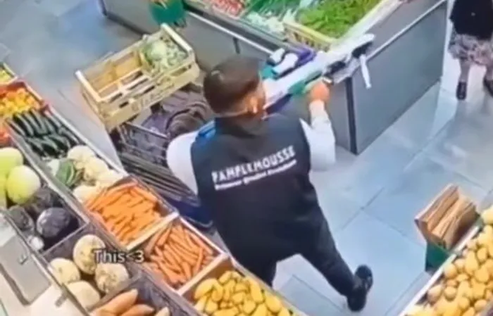 Elderly woman and supermarket worker have a standoff