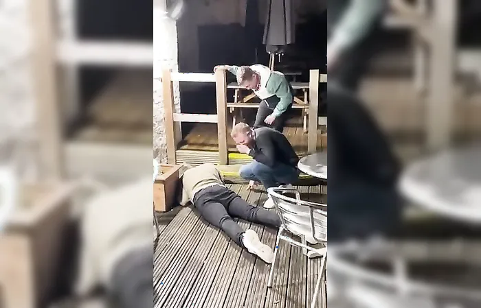 drunk guys keep slipping on ice, can't stop laughing
