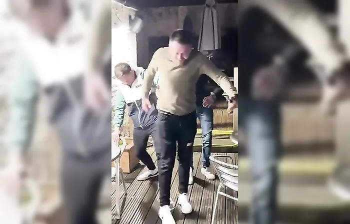 drunk guys keep slipping on ice, can't stop laughing