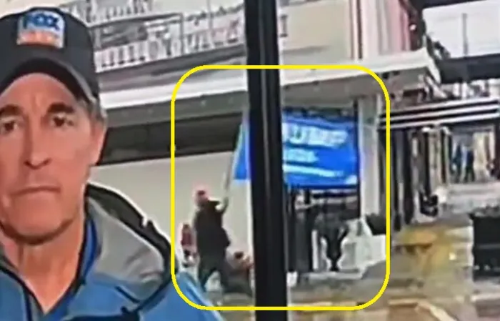 Reporter covers camera when Trump flag goes by