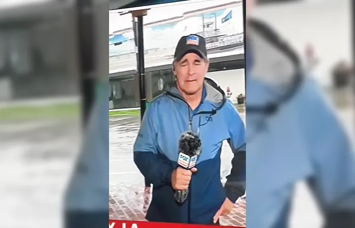 Reporter covers camera when Trump flag goes by