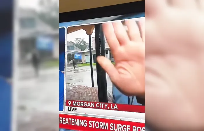 Reporter covers camera when Trump flag goes by
