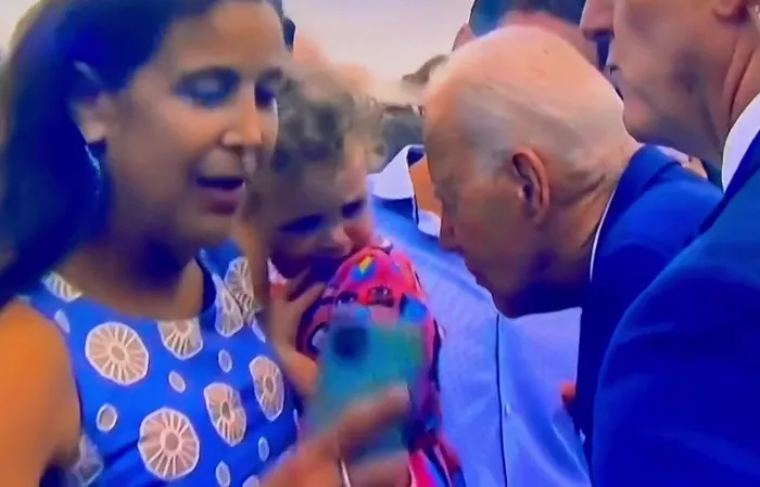 Little Girl Looks Terrified as Biden Appears To Nibble on Her Back