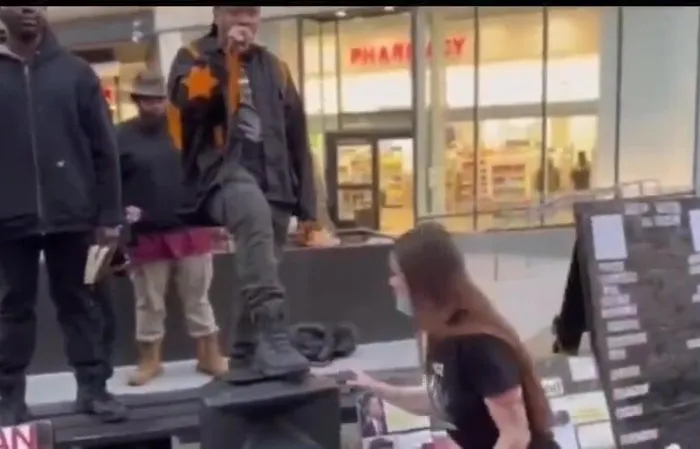 Woman bends at the knee to become a real life boot licker