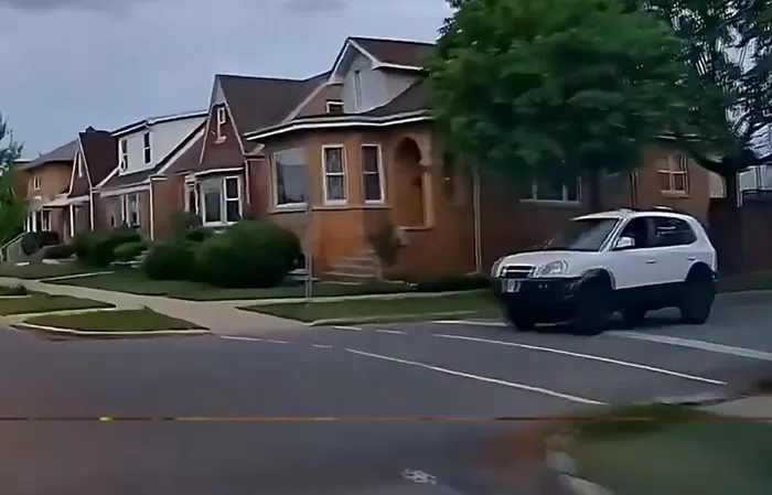 Woman blows through a stop sign, then shatters someone's window