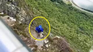 Dude jumps off cliff with rare wing-suit