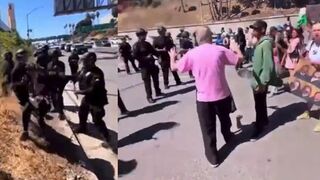 Actress Jodie Sweetin, from Full House, gets tossed by riot cops