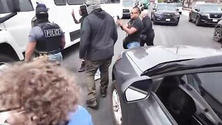 Protesters jump on ICE vehicle, clash with officers