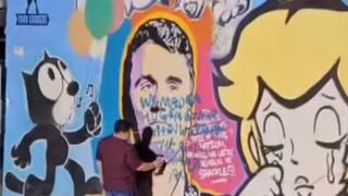 Artist Pop Culture fixes a mural of Charlie Kirk in Edinburg, Texas