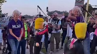 Elderly woman beats up a Trump effigy