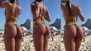 Water glistens on the beach thong