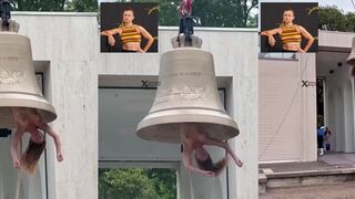 Weirdo activist hangs topless inside a giant bell
