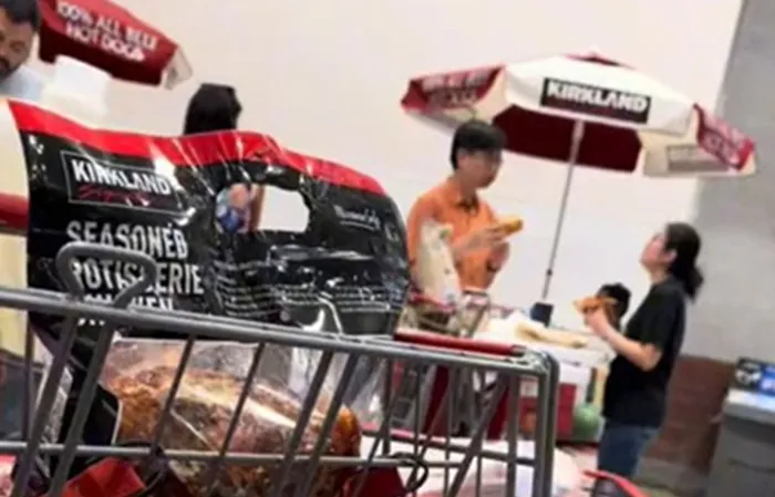 Eating a pizza wrapped Costco hotdog