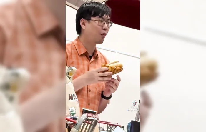 Eating a pizza wrapped Costco hotdog