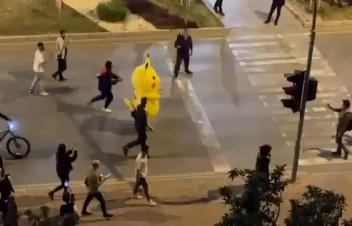 Pikachu runs from the cops at protest