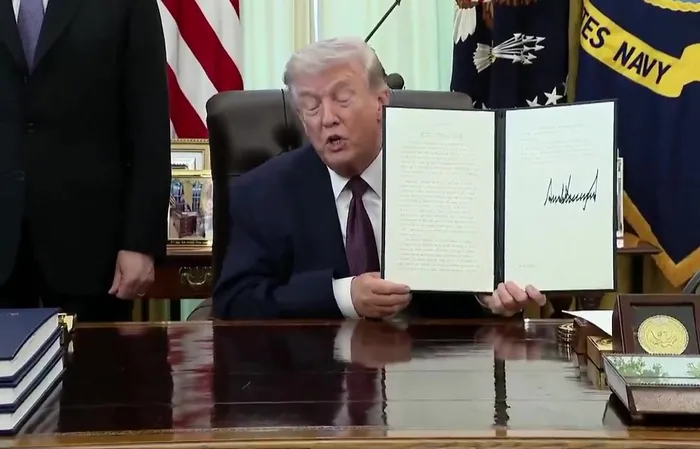 Trump uses a REAL PEN to sign a landmark Executive Order