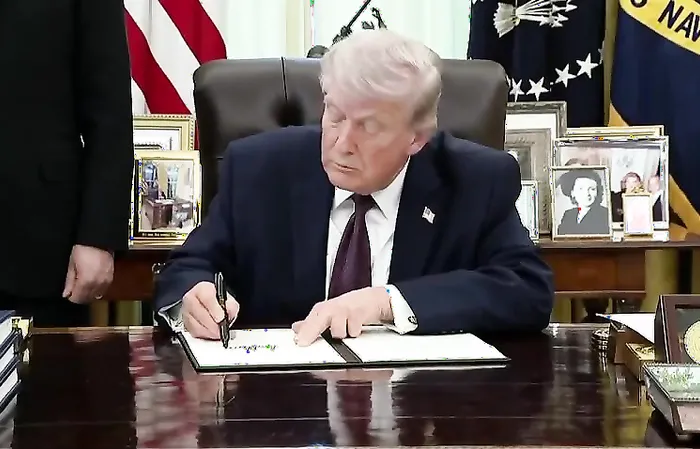 Trump uses a REAL PEN to sign a landmark Executive Order