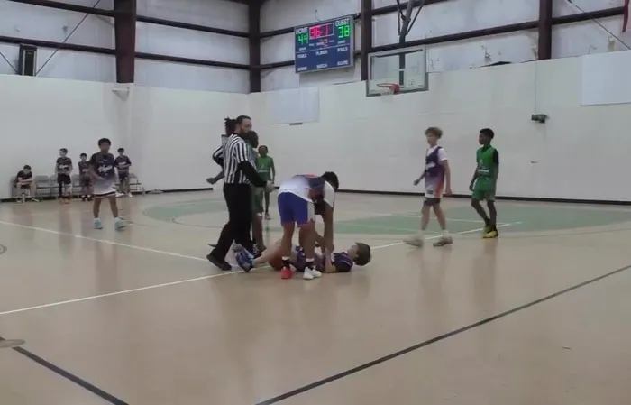 Thug attacks someone during basketball game