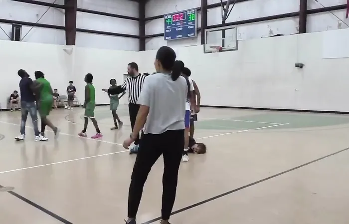 Thug attacks someone during basketball game
