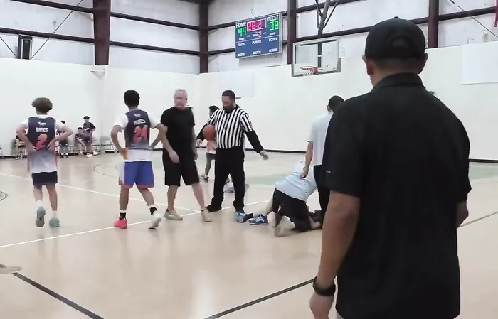 Thug attacks someone during basketball game