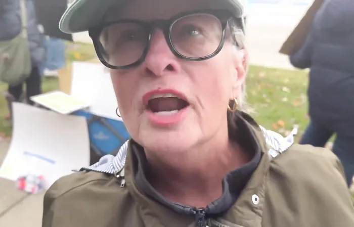 Woman holding sign that makes NO SENSE has epic meltdown