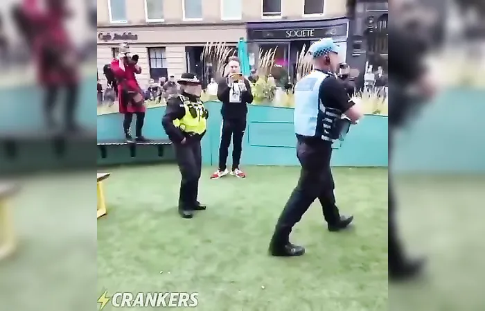 Police officer RIPS a Union Jack flag because it was offending migrants