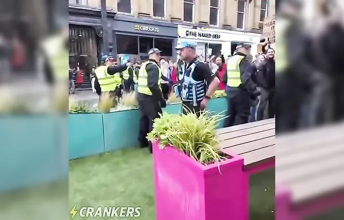 Police officer RIPS a Union Jack flag because it was offending migrants