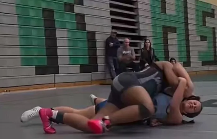 Female wrestler touched inappropriately by male wrestler