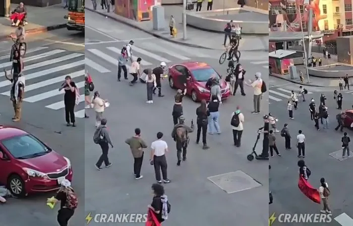 Protester gets ran over while trying to stop a vehicle