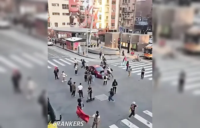 Protester gets ran over while trying to stop a vehicle