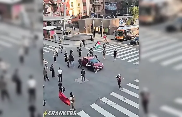 Protester gets ran over while trying to stop a vehicle