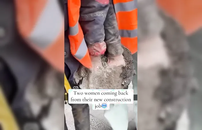 Two protesters have hands stuck in concrete