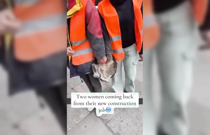 Two protesters have hands stuck in concrete