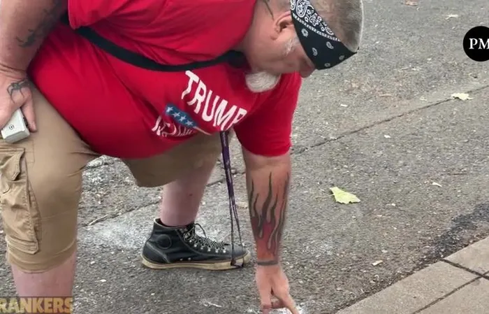 Anti-ICE protester rubs pepper ball residue in his gum to show off
